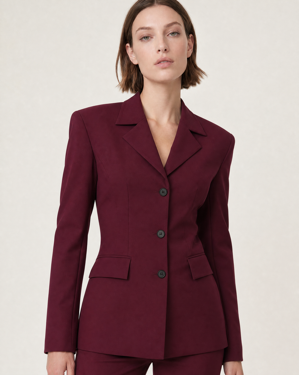 Anna wearing a burgundy Corja Milena jacket, styled as a fashionable women's coat on a clean light background.