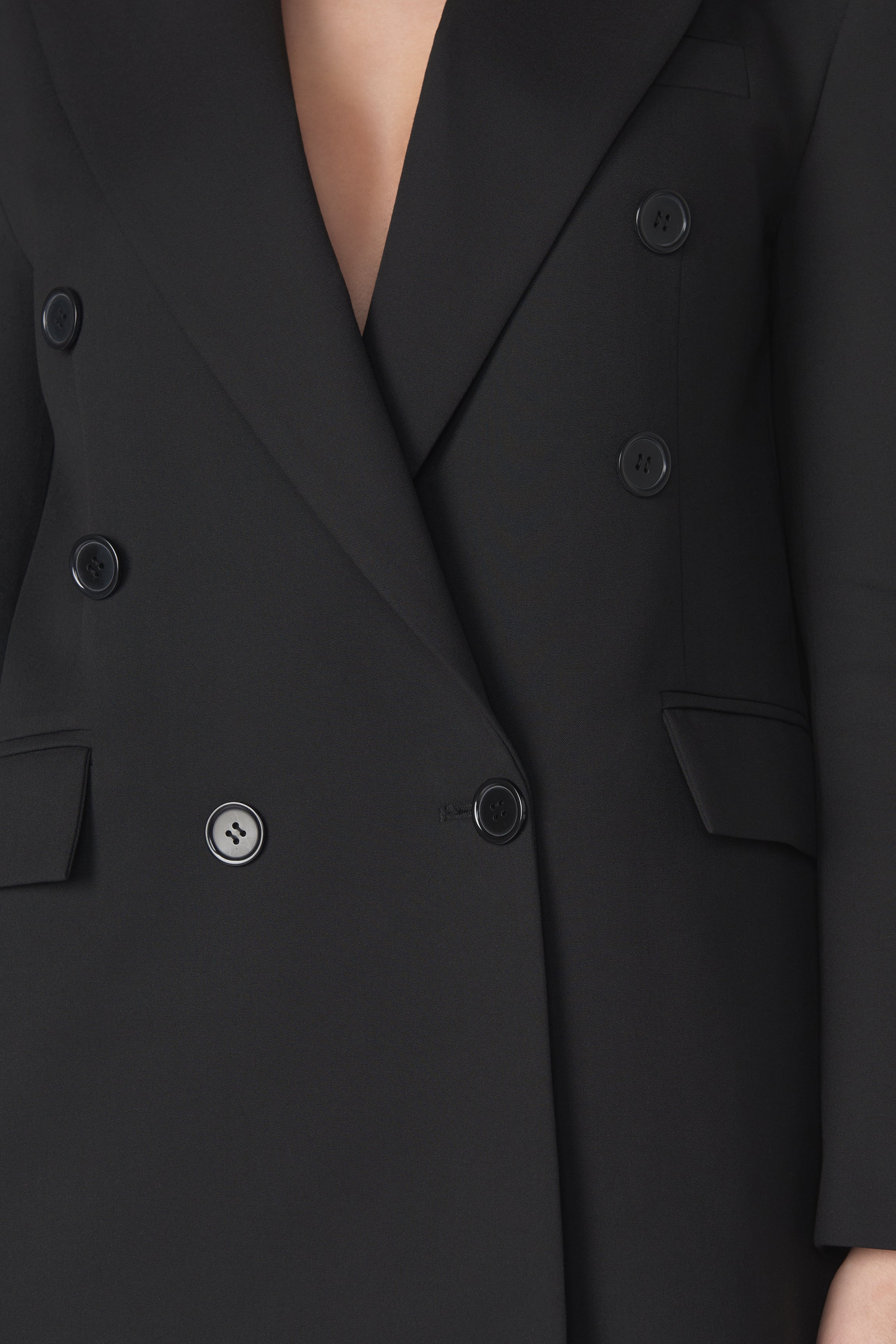 Close-up of the Corja The Blazer showing detailed fabric texture and classic tailored design.