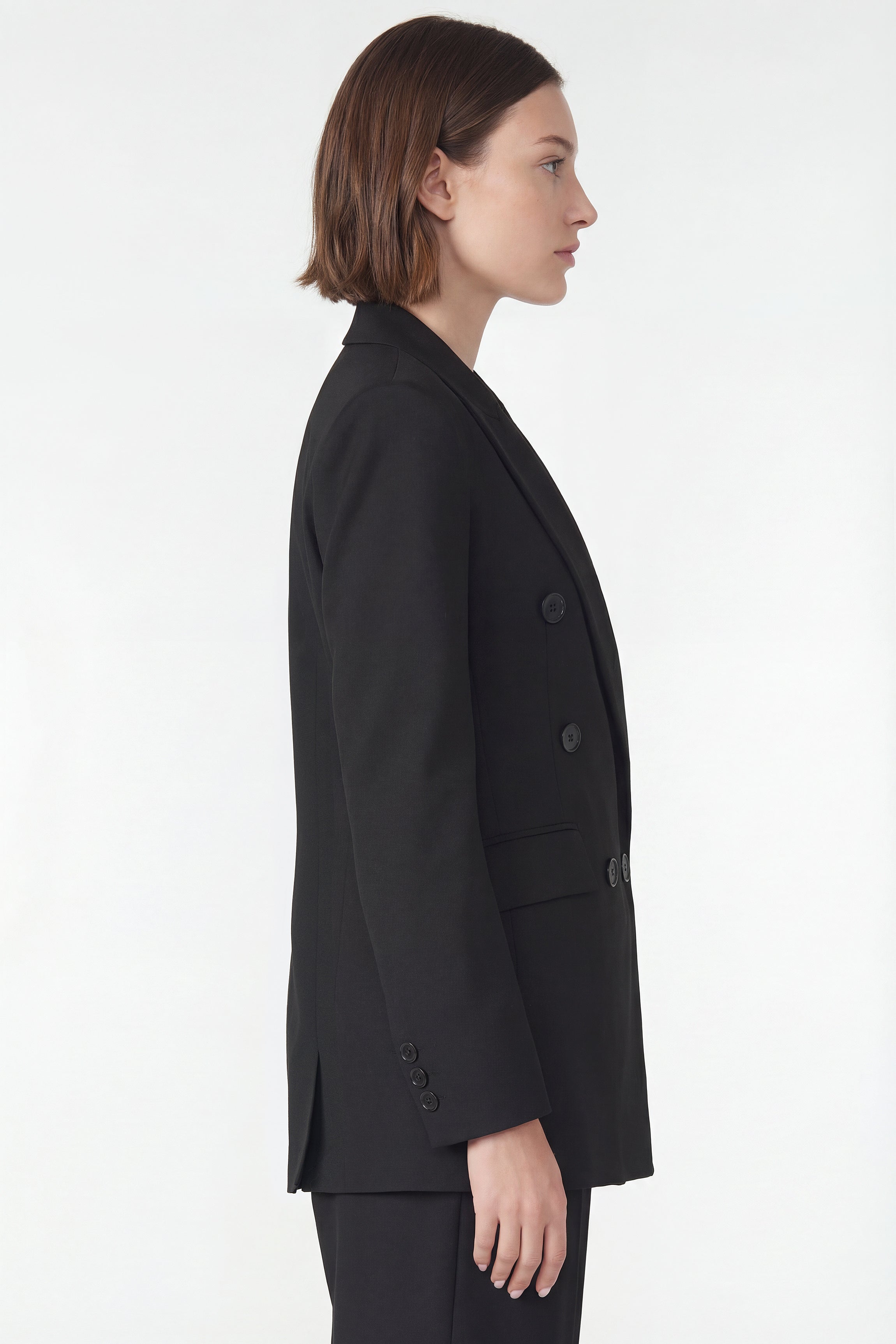 Side view of Corja The Blazer, a stylish tailored blazer in a classic fit with lapel collar and button closure.