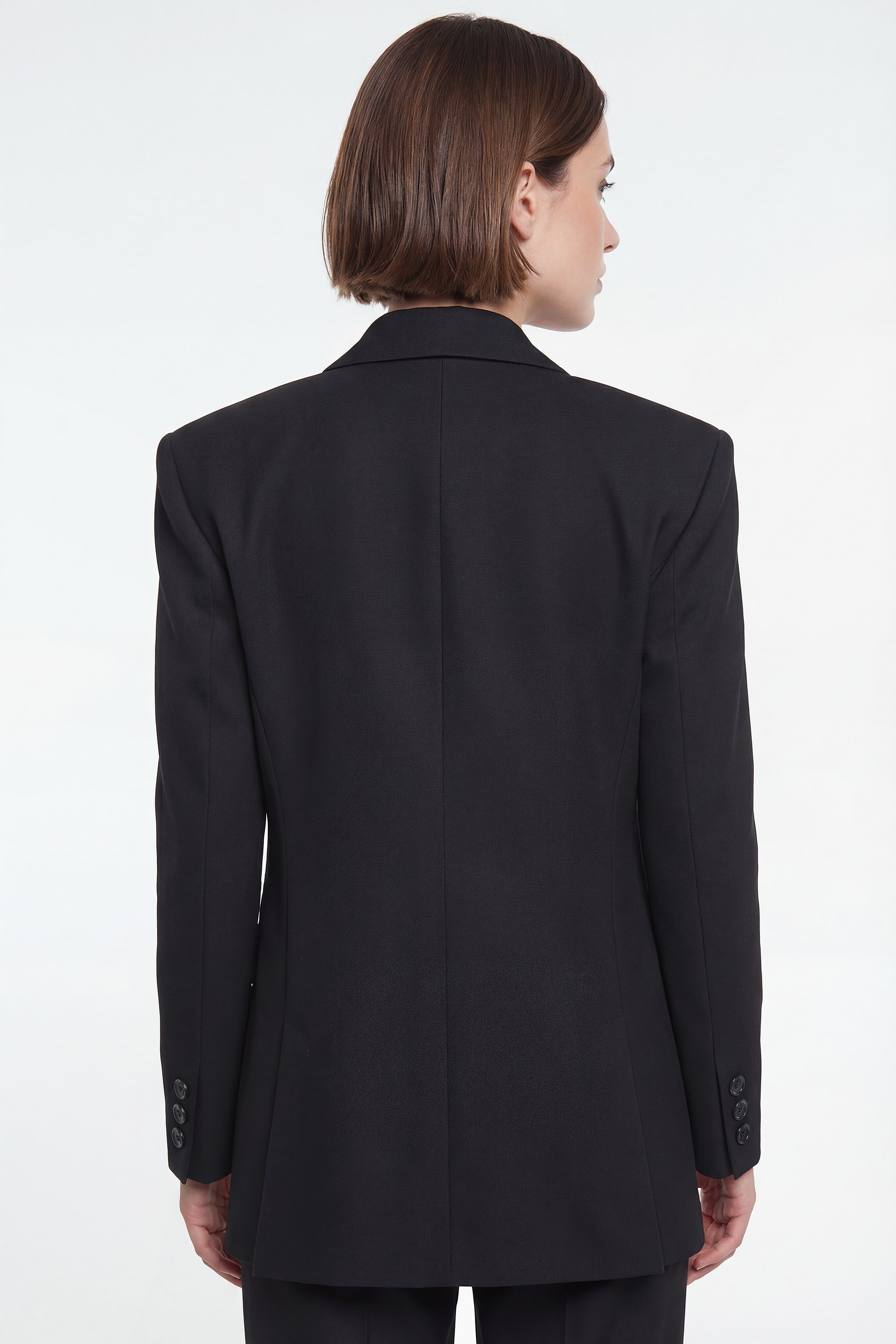 Back view of corja The Blazer in a tailored design, featuring structured shoulders and classic lapels.
